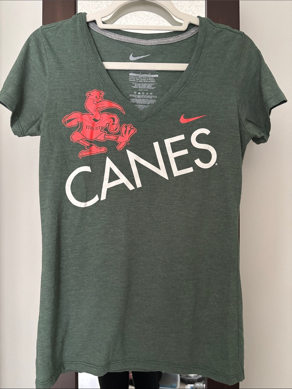 Nike Women’s Dark Green V-Neck CANES Tee with Coral Logo